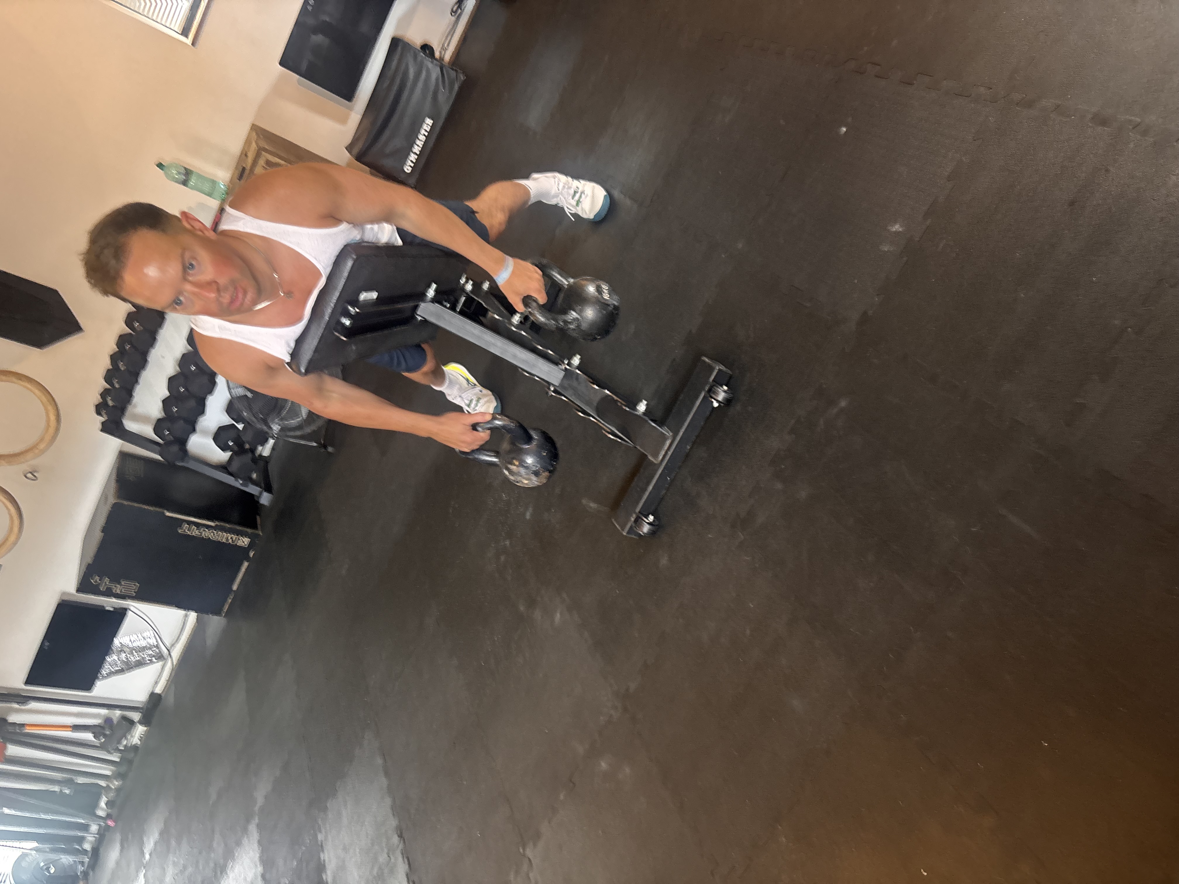 Client lifting dumbbells during a coached session