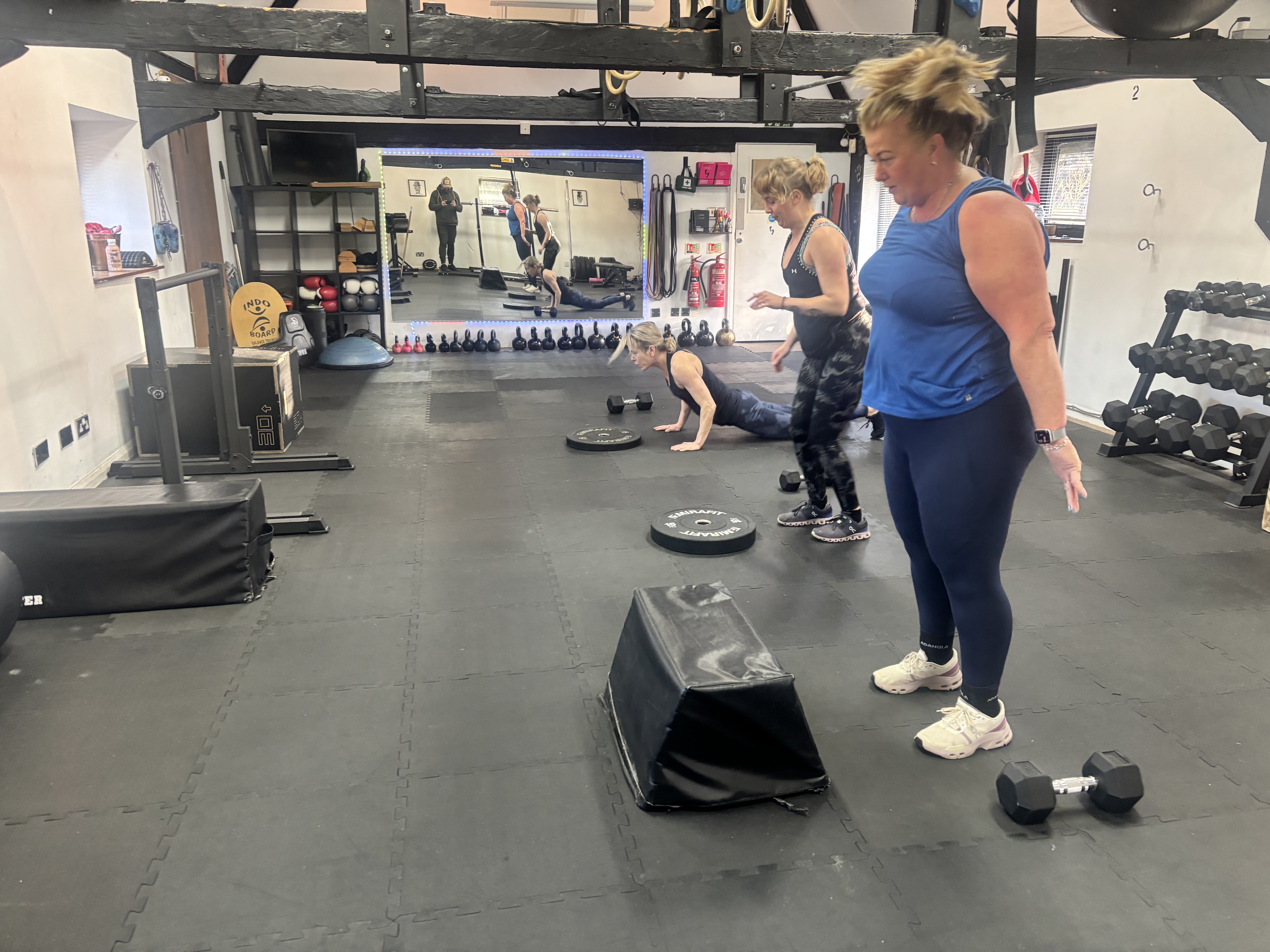 Coach guiding members through a coached kettlebell session